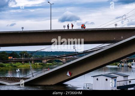 Les ouvriers se tiennent sur la partie intacte du pont Carola partiellement effondré, une partie du pont brisée dans l'Elbe. Banque D'Images