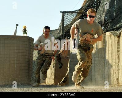 Photo du duc de Sussex à l'âge de 28 ans. Photo de dossier datée du 03/11/2012 du prince Harry (à droite) ou tout simplement du capitaine Wales comme il est connu dans l'armée britannique, court de la tente VHR (Very high ready-ness) pour brouiller son Apache avec d'autres pilotes, pendant son quart de travail de 12 heures à la ligne de vol contrôlée par les Britanniques dans le camp Bastion sud de l'Afghanistan, où il sert comme pilote/artilleur hélicoptère Apache avec le 662 SQD Army Air corps. Le duc de Sussex célébrera son 40e anniversaire dimanche. Date d'émission : vendredi 13 septembre 2024. Banque D'Images