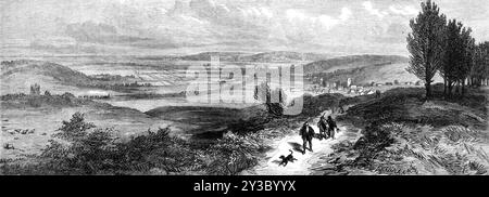 Vue près de Sandringham, en regardant vers le nord-ouest à Dersingham et le chemin de fer à Wolferton, 1871. Campagne autour de Sandringham dans le Norfolk, l'une des résidences de la famille royale britannique, vu '...from le parc ou les jardins de Sandringham, en regardant vers le nord-ouest - c'est-à-dire à travers la ligne de chemin de fer, et dans la direction de la Wash. Le village vu sur la droite est Dersingham, vers lequel le train vient de la gare de Wolferton. Ces deux endroits se trouvent sur un sol plus bas que les collines ondulantes de Sandringham, qui sont composées de dérive ou de gravier, et doit avoir été le bo original Banque D'Images