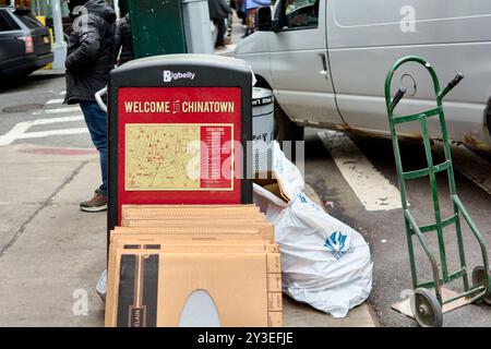 New York, États-Unis -13 septembre 2024 : image d'un bac de recyclage Bigbelly au cœur de Chinatown, New York, entouré de boîtes en carton et p Banque D'Images