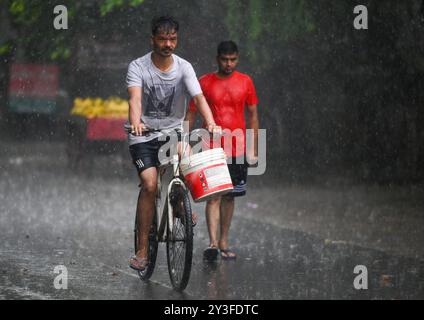 Noida, Inde. 13 septembre 2024. NOIDA, INDE - 13 SEPTEMBRE : les navetteurs sortent sous la pluie soudaine de l'après-midi, le 13 septembre 2024 à Noida, Inde. Le département météorologique indien (IMD) a émis une alerte « orange », indiquant un mode « soyez prêt », car des conditions météorologiques extrêmement mauvaises sont prévues. (Photo de Sunil Ghosh/Hindustan Times/Sipa USA ) crédit : Sipa USA/Alamy Live News Banque D'Images