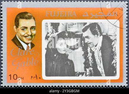 Timbre-poste oblitéré imprimé par Fujairah (Fujeira), qui montre la star de cinéma - Clark Gable, vers 1972. Banque D'Images