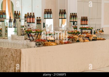 Table de buffet élégante et abondante avec des hors-d'œuvre exquis et des boissons dans un cadre luxueux. Banque D'Images