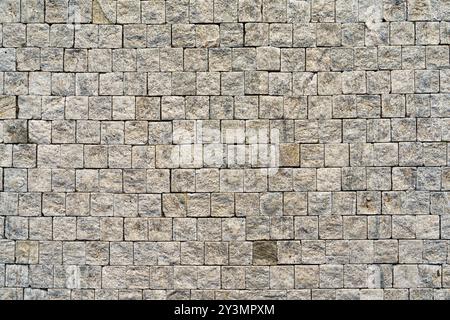 Fond grunge de pavés de granit altérés dans des tons terreux Banque D'Images