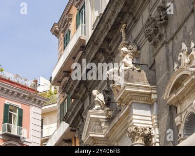 Façade d'un bâtiment historique décoré de statues ornées et de détails architecturaux, naples, mer méditerranée, italie Banque D'Images