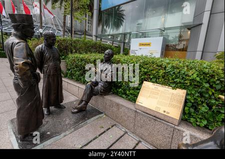 À la base de la tour Maybank de 32 étages se trouvent des statues appelées «marchands de rivière» représentant des scènes historiques du début de Singapour au XIXe siècle Banque D'Images