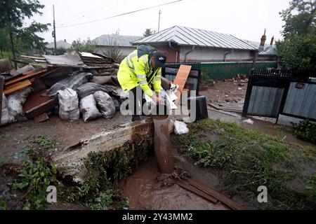 Galati, Roumanie. 15 septembre 2024. Un homme nettoie les eaux de crue à sa résidence dans le comté de Galati, Roumanie, le 15 septembre 2024. Le comté de Galati, en Roumanie, peine à se remettre des graves inondations provoquées samedi par le cyclone Boris, qui a coûté la vie à cinq personnes et déplacé plus de 250 résidents. Crédit : Cristian Cristel/Xinhua/Alamy Live News Banque D'Images