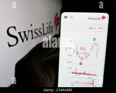 Allemagne. 16 août 2024. Dans cette illustration photo, une personne tient un smartphone avec le site Web de la compagnie d'assurance Swiss Life Holding AG devant le logo de l'entreprise. Crédit : SOPA images Limited/Alamy Live News Banque D'Images