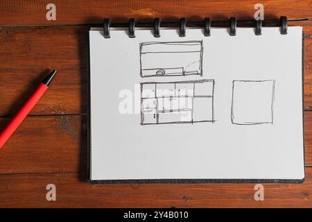 Une page de carnet de croquis avec des croquis dessinés à la main d'une disposition de cuisine et un espace vide. Les croquis comprennent des armoires, un évier et un design de comptoir. A R Banque D'Images