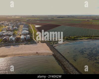 Vue aérienne des habitations côtières, des jardins maraîchers et des terres cultivées au bord de la baie de Port Phillip à Werribee South, Victoria, Australie Banque D'Images