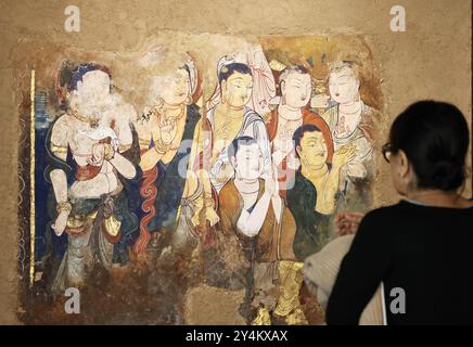 Paris, 18 septembre. 24 septembre 2024. Une femme visite la route de la soie Danqing, une exposition de copies de peintures murales de temples rupestres le long de l'ancienne route de la soie au Centre culturel chinois à Paris, France, 18 septembre 2024. L'exposition durera jusqu'au 24 septembre 2024. Crédit : Gao Jing/Xinhua/Alamy Live News Banque D'Images