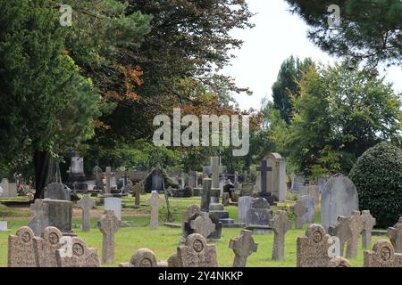 Gosport, Hampshire, Angleterre. 13 septembre 2024. Scène de cimetière avec arbres et pierres tombales. Cette photo fait partie d'une série que j'ai prise lors d'une récente visite au cimetière de la Marine royale de Haslar pendant les Journées portes ouvertes du patrimoine de Gosport. Cette sélection comprend quelques photos que j'ai prises sur le chemin de l'événement et en dehors, alors que j'étais à pied. Banque D'Images