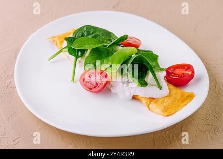 Omelette avec tomates et herbes sur une assiette Banque D'Images