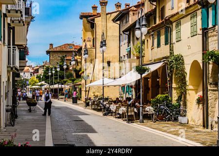 GRADO, ITALIE – 2 JUIN 2024 : rue centrale de Grado, une charmante ville balnéaire connue pour son architecture historique et sa vie locale animée. Un populaire à Banque D'Images