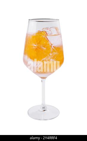 Verre à vin en cristal rempli d'une boisson orange vibrante et de glace, isolé sur blanc Banque D'Images