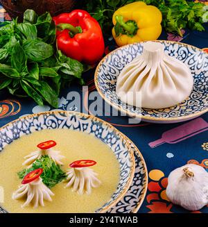 Cuisine traditionnelle géorgienne khinkali sur des assiettes avec des herbes et des épices sur une nappe Banque D'Images