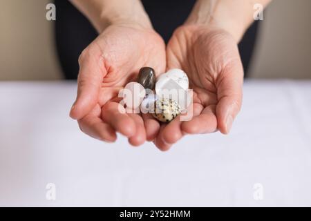 Gros plan des mains de la femme tenant des cristaux pour la guérison énergétique Reiki Banque D'Images