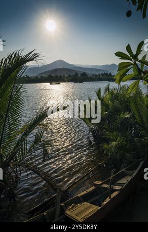 Vue sur la rivière exotique tropicale au coucher du soleil à kampot cambodge asie avec bateau de pêche Banque D'Images