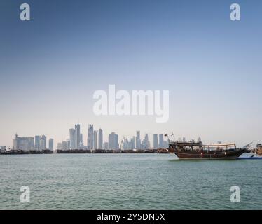 Gratte-ciel de Doha vue sur l'horizon urbain et bateau de boutre au qatar Banque D'Images