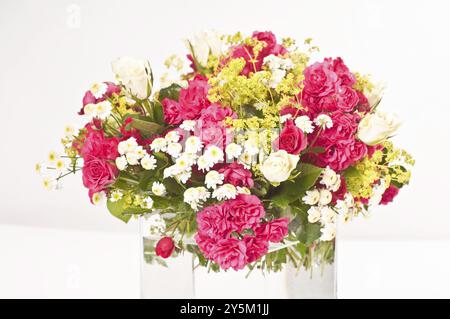 Bouquet coloré en rose, jaune-vert et blanc dans un vase en verre Banque D'Images