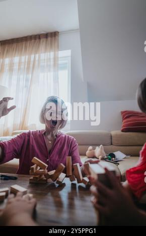 Femme frustrée réagissant à la chute de blocs de bois pendant le match Banque D'Images