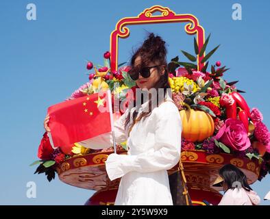 Pékin, Chine. 23 septembre 2024. Les touristes posent pour une photo de groupe devant les parterres de fleurs de la place Tian 'anmen pour célébrer la prochaine fête nationale à Pékin, en Chine, le 23 septembre 2024. (Photo de Costfoto/NurPhoto) crédit : NurPhoto SRL/Alamy Live News Banque D'Images