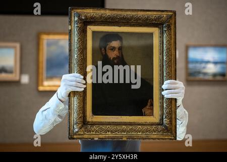 Londres, Royaume-Uni. 23 septembre 2024. Un technicien présente « Portrait of Lucas Alexander Ionides », 1859, de James McNeill Whistler (est. £80 000 - 120,000) lors d’un aperçu de la vente d’art britannique et impressionniste du XIXe siècle à Bonhams. Les lots seront mis aux enchères le 25 septembre et les galeries Bonhams New Bond Street. Credit : Stephen Chung / Alamy Live News Banque D'Images