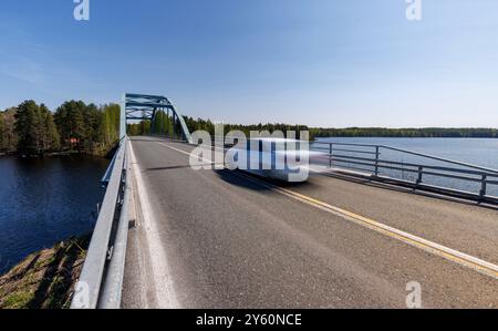 Voiture blanche traversant Kivisalmi pont routier finlandais à été, Finlande Banque D'Images