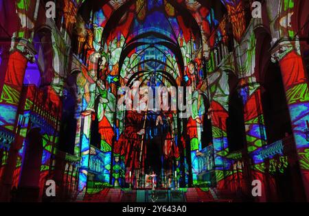 Une vue du spectacle immersif de lumière et de son Crown and Coronation, à la cathédrale de Canterbury dans le Kent. Crown and Coronation entreprend une visite dans tout le Royaume-Uni des monuments et lieux célèbres jusqu'en décembre 2025. Le spectacle a été créé par Historic Royal Palaces en partenariat avec Luxmuralis, dans le cadre d’une collaboration artistique entre l’artiste Peter Walker et le compositeur David Harper. Date de la photo : lundi 23 septembre 2024. Banque D'Images