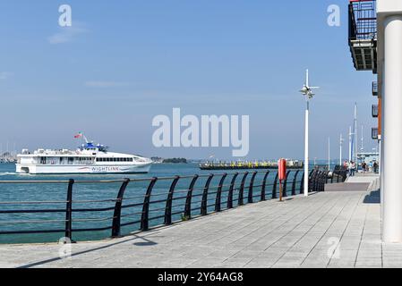 Promenade à côté de Gunwharf Quays à Portsmouth, avec un catamaran Wightlink sur le point d'accoster au loin. Septembre 2024. Banque D'Images