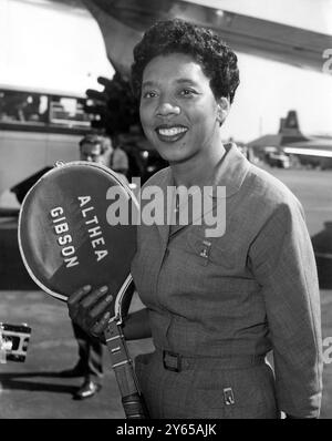 Althea Gibson , la championne féminine en titre de Wimbledon , arrive ici , raquettes de tennis en main , à l'aéroport de Londres . Bien qu'elle ne soit pas en compétition , Althea fera un reportage sur le championnat de Wimbledon pour un journal du soir . 17 juin 1959 Banque D'Images