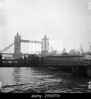 Répétition à l'aube avec Tower Bridge en arrière-plan , huit gardes grenadiers blancs gantés portant un cercueil drapé de drapeau au bord de l'eau à Tower Pier , pendant la répétition pour les funérailles de Sir Winston Churchill . 26 janvier 1965 Banque D'Images