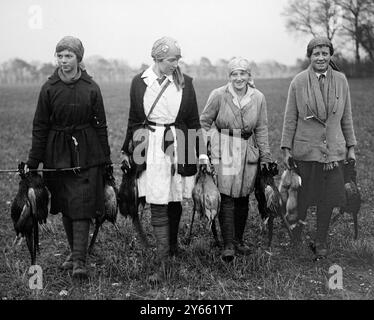 Les battes de fille sur un domaine de campagne dans le Norfolk transportant les oiseaux de gibier à la charrette de ferme. 19 janvier 1918 Banque D'Images