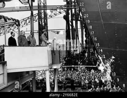 La reine Elizabeth regarde une bouteille de champagne balancer contre le côté du «navire à passagers le plus révolutionnaire du monde» alors qu'elle le baptise «Southern Cross» lors de la cérémonie de lancement au chantier naval Harland and Wolff à Belfast, en Irlande du Nord. Avec la Reine sont LtoR Sir Frederick Rebbeck , président et directeur général des constructeurs , Lord Wakehurst , gouverneur d'Irlande du Nord et M. Basil Sanderson , président et directeur général de la Shaw Savill and Albion Line pour qui le navire a été construit le .18 août 1954 Banque D'Images