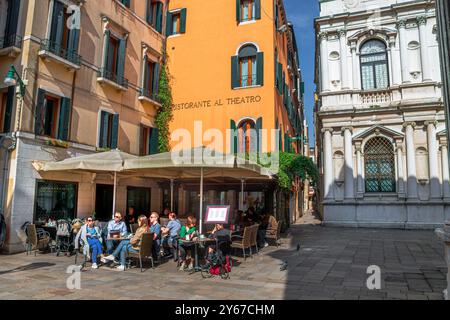 Les gens assis dehors appréciant le café et les boissons au Ristorante Al Theatro à Campo San Fantin dans le sestiere San Marco de Venise, Italie Banque D'Images