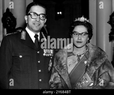 Londres : le roi Mahendra et la reine Ratna du Népal arrivent ce soir à l'ambassade du Népal pour un dîner donné par eux aux membres de la famille royale britannique. Les 65 invités comprenaient la reine, le prince Philip, la princesse Margaret et Anthony Armstong-Jones, le duc et la duchesse de Gloucester, la princesse royale, la duchesse de Kent, le duc de Kent et la princesse Alexandra. La reine Elizabeth portait du tulle aigue-marine, et le prince Philip était habillé de cravate et de queues blanches. Une traînée de roses rouge foncé courant le long des tables formait le motif de la décoration de table au dîner. 18 octobre 1960. Banque D'Images