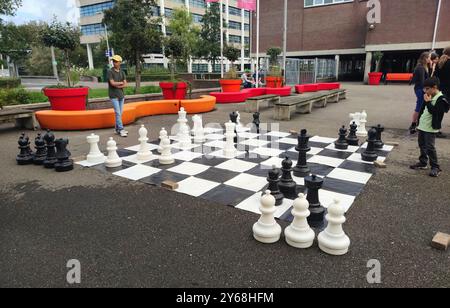 Les gens jouent une partie d'échecs sur un immense échiquier pour le plaisir lors d'un tournoi d'échecs rapide dans la ville de Gouda, aux pays-Bas. Banque D'Images