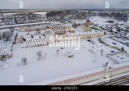 Ancien monastère de Tikhvin Assomption dans un paysage de mars par un jour nuageux (photographie aérienne). Tikhvin, région de Leningrad. Russie Banque D'Images