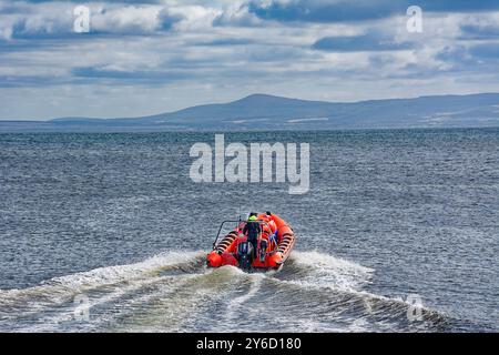 Lossiemouth Moray Firth Écosse à la fin de l'été bateau gonflable rouge Mutineer avec des passagers se dirigeant vers la mer ouverte Banque D'Images