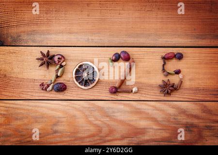 2025 écrit avec des épices de Noël et des fruits secs sur fond en bois, carte de voeux de nouvel an Banque D'Images