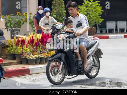 BETONG, THAÏLANDE, Mar 02 2024, Un homme monte moto avec un petit garçon dans le centre-ville Banque D'Images