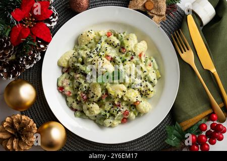 Délicieux gnocchi avec sauce yaourt et asperges vertes. Table vue sur le dessus avec décorations de Noël. Banque D'Images