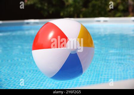 Balle gonflable dans la piscine hors sol à l'extérieur le jour ensoleillé Banque D'Images