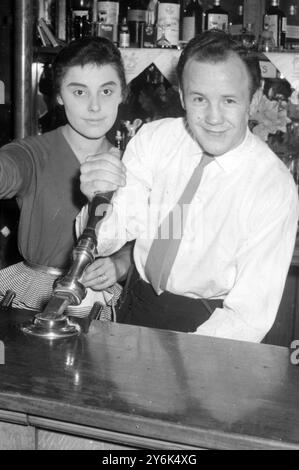 Sammy McCarthy, 26 ans, ancien champion britannique poids plume, totalisera bientôt des pintes au lieu des points lorsqu'il prendra la relève comme ' mine Host ' au Prince of Wales public House Duckett Street , Stepney . Surveillé par sa femme Sylvia. 8 avril 1958 Banque D'Images