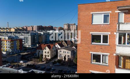 Un immeuble d'appartements en briques moderne avec plusieurs balcons, vitrine. La structure dispose de grandes fenêtres et d'un design contemporain, entouré de o Banque D'Images