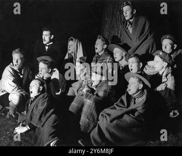 Célébrant leur Jamboree du Festival de 1951, les éclaireurs de Woolwich se rassemblent pour une chanson de camp à la fin de la journée dans la forêt d'Abbey Wood. - 17 mai 1951. ©TopFoto Banque D'Images