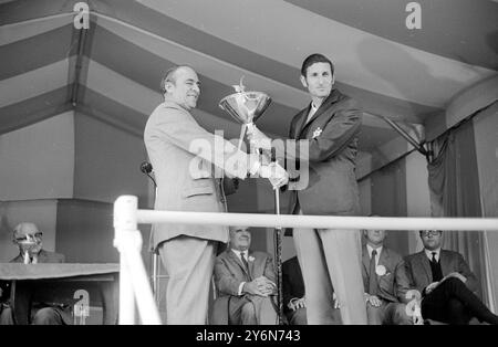 Wentworth, Angleterre : le gaucher néo-zélandais Bob Charles reçoit le trophée de m. Philip Bulpit, chariman de carreras, après avoir remporté la finale du Championnat du monde de golf piccadilly. Il a battu l'américain Gene Littler dans une finale palpitante de 36 trous. Ils étaient tous carrés après le 36e et au match de la mort suden qui a suivi, Charles a fait un merveilleux aigle trois au 37e pour remporter le titre et le premier prix de £5 750. 11 octobre 1969 Banque D'Images