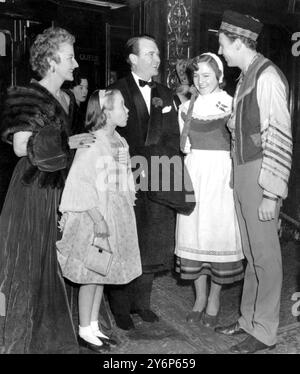 Londres : avant d'entrer au Carlton Theatre, Haymarket pour assister à la première du film 'Hans Christan Andersen' acteur John Mills avec sa femme et sa fille 'Bunchy', discuter avec Doris Kofod de Bornholm, au Danemark, et le londonien Lew Lane, qui portent tous deux des costumes. Danny Kaye, le comédien américain, joue dans le film qui a un certain nombre de scènes de ballet basées sur les contes de fées d'Andersen. 19 décembre 1952. L'année 2005 marque le 200e anniversaire de la naissance de Hans Christian Andersen. Pour cette raison, il y aura une célébration mondiale pour se souvenir et honorer l'auteur danois. Banque D'Images