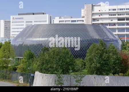 Vue sur le Pavillon Novartis, un complexe de bâtiments circulaires construit sur un campus universitaire. La façade est composée de milliers de cellules solaires. Banque D'Images