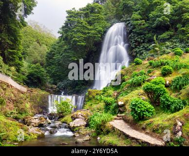 Cascade à Ribeira dos Caldeirões dans le Nordeste avec des touristes, île de Sao Miguel dans les Açores. Banque D'Images